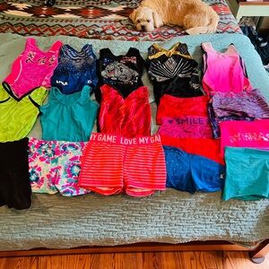 8 gently used leotards and 11 pairs of gymnastics shorts sizes child sm-lg